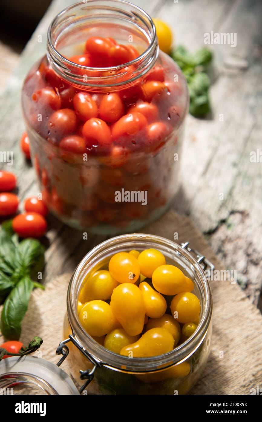 red and yellow cherry tomatoes in a jar for winter Stock Photo - Alamy