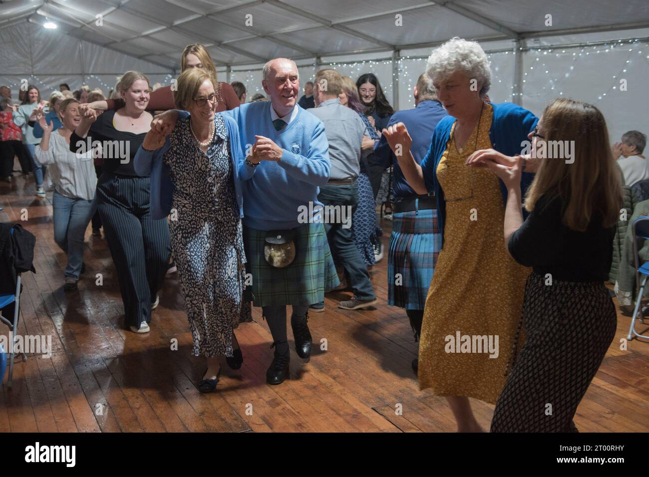 Scottish ceilidh dancing to traditional folk music. Cockenzie and Port Seton Friendly Society of Fishermen. The Box Meeting Ceilidh. Former fisherman and skipper Archie Johnston 86 yrs old dancing with his daughter Jane in a marquee erected at the harbour, especially for the event. September 2023 Cockenzie and Port Seton, East Lothian, Scotland. 2020s UK HOMER SYKES Stock Photo