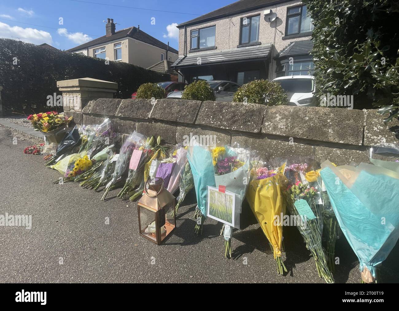 File photo dated 8/4/2023 of floral tributes left outside a house on Hemper Lane, Greenhill, Sheffield, following the death of Marcia Grant. A 13-year-old boy has admitted killing a grandmother by driving over her in her own car. Marcia, 60, died outside her home in the Greenhill area of Sheffield on April 5. The youngster, who was 12 at the time of the incident and cannot be named, was due to go on trial this week accused of murder. But on Tuesday he pleaded guilty at Sheffield Crown Court to causing Mrs Grant's death by dangerous driving and this was accepted by prosecutors. Issue date: Tues Stock Photo