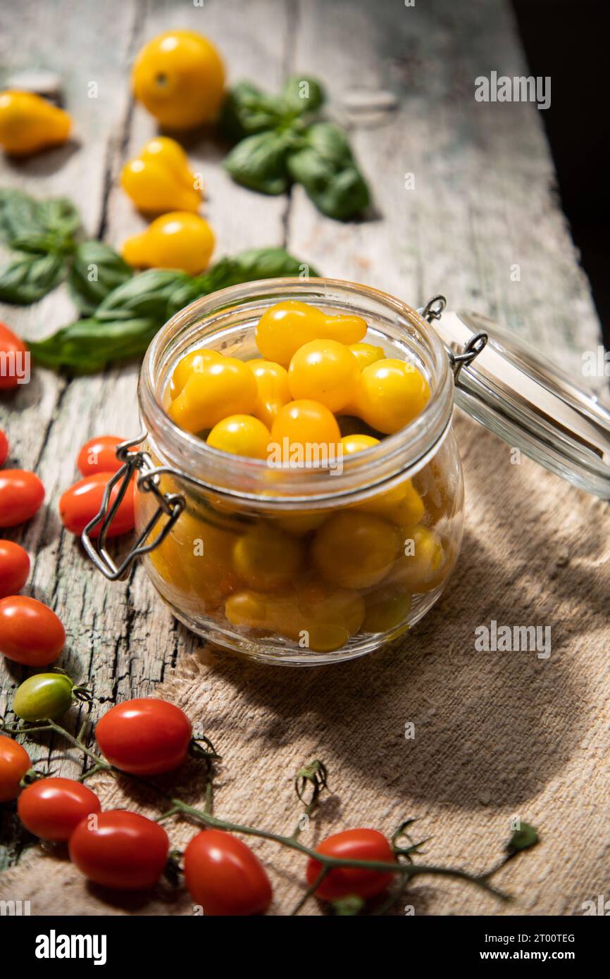 red and yellow cherry tomatoes in a jar for winter Stock Photo - Alamy