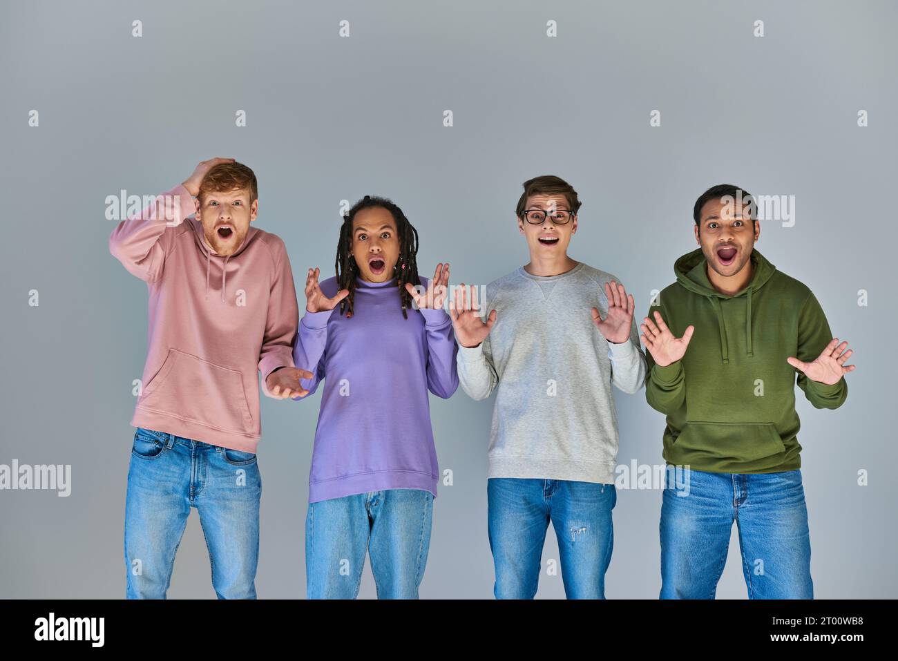 four surprised multicultural friends in urban outfits looking at camera, cultural diversity Stock Photo