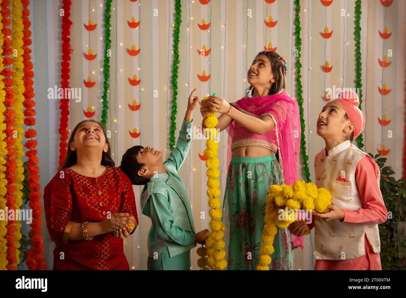 Group Of Children Dressed In Traditional Attire Decorate Their Home 