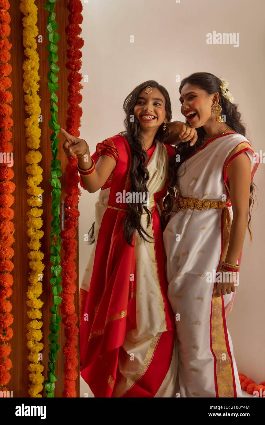 Portrait of two Bengali sister in traditional outfit standing together