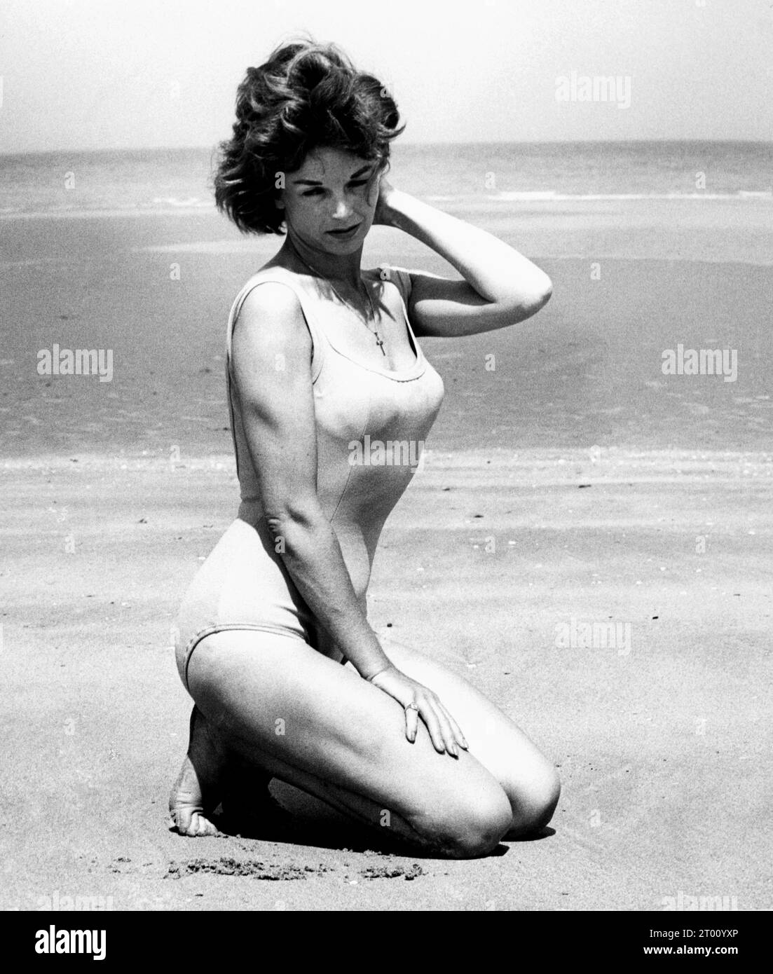 Dawn Addams on the beach ca. 1956 Stock Photo