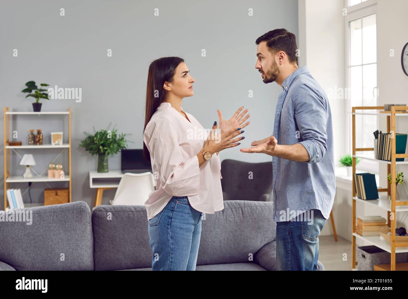 Emotional stressed young couple having argument at home Stock Photo