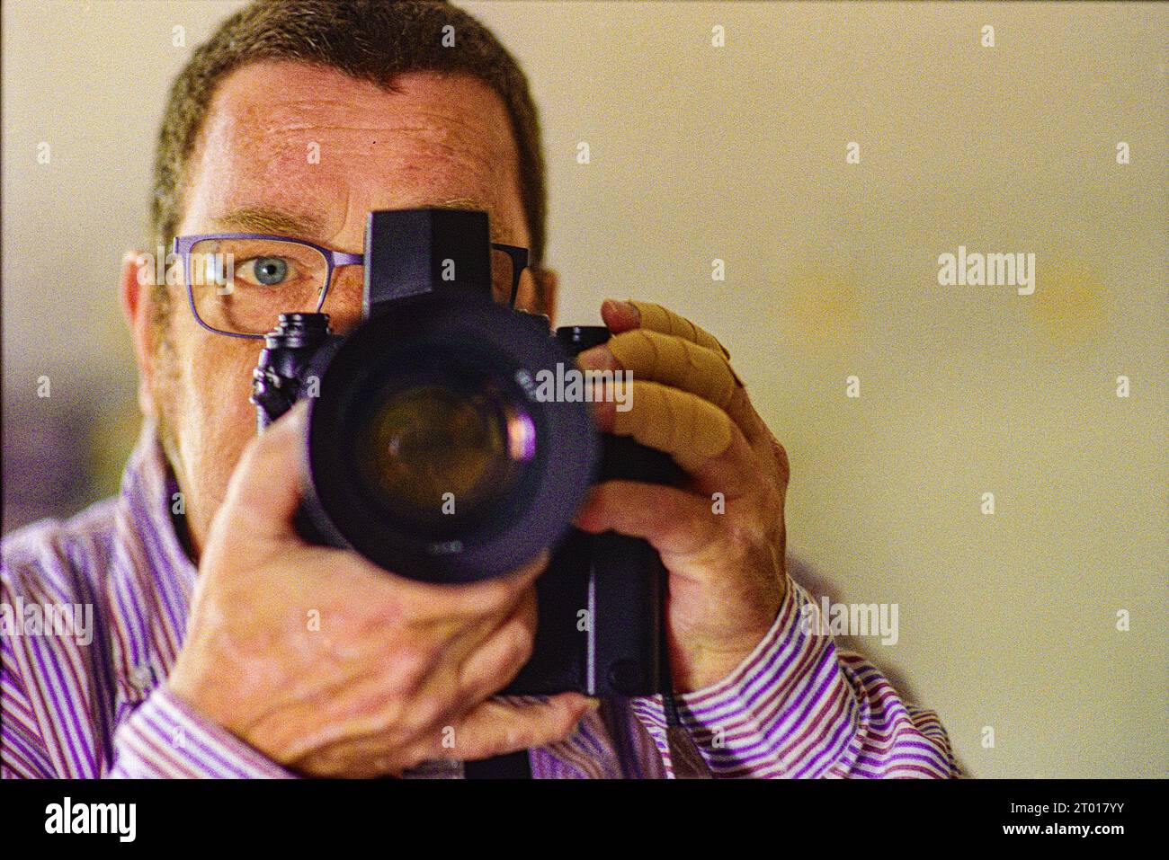Self Portrait with Nikon F3 Analog Photo Camera inside mirror. Tilburg