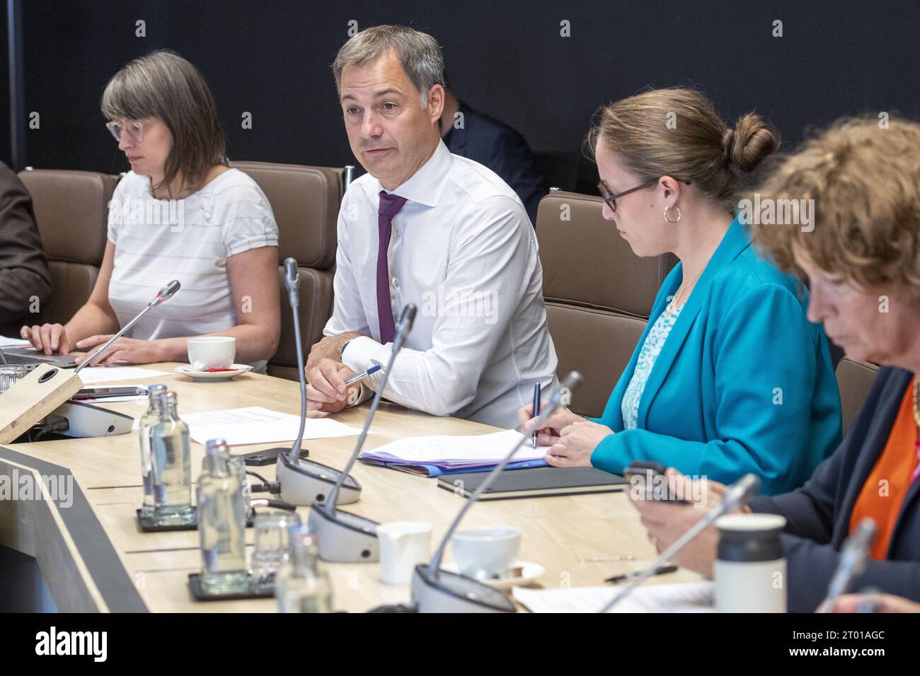 Prime Minister Alexander De Croo (2L), State Secretary for Asylum and Migration policy Nicole de Moor and Vice-prime minister and minister of Civil Services and State-owned companies Petra De Sutter pictured during a meeting of the federal government task force responsible for finding 2,000 temporary places to house asylum seekers, in Brussels, Tuesday 03 October 2023. This is the first meeting of the task force, several administrations and agencies are taking part, including the Federal Agency for the Reception of Asylum Seekers Fedasil, the Ministry of Defense, the Federal Public Health Serv Stock Photo