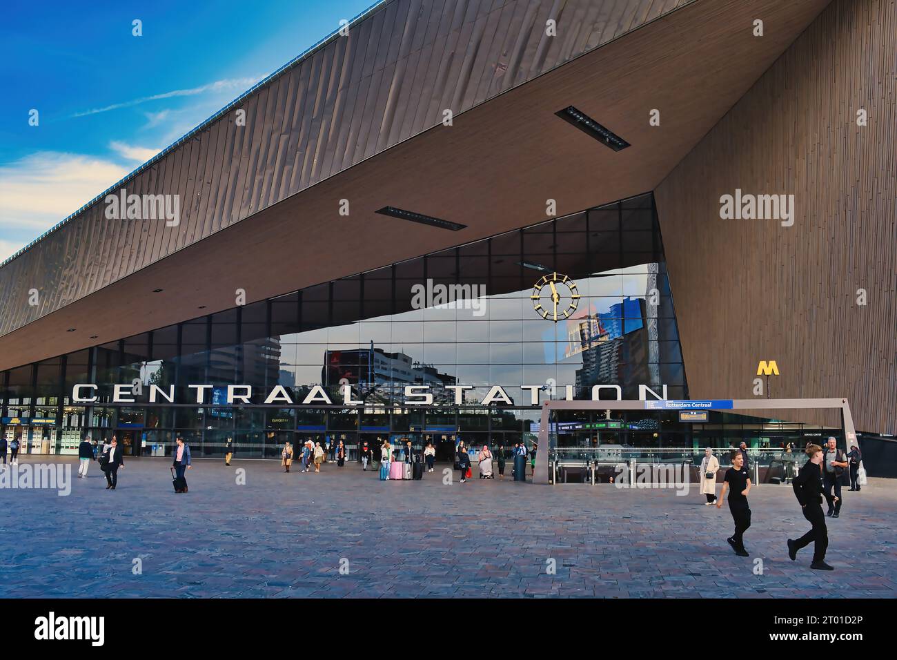 The entrance to the modern building of Rotterdam Central Station. Reflection of surrounding buildings in the glass. Stock Photo