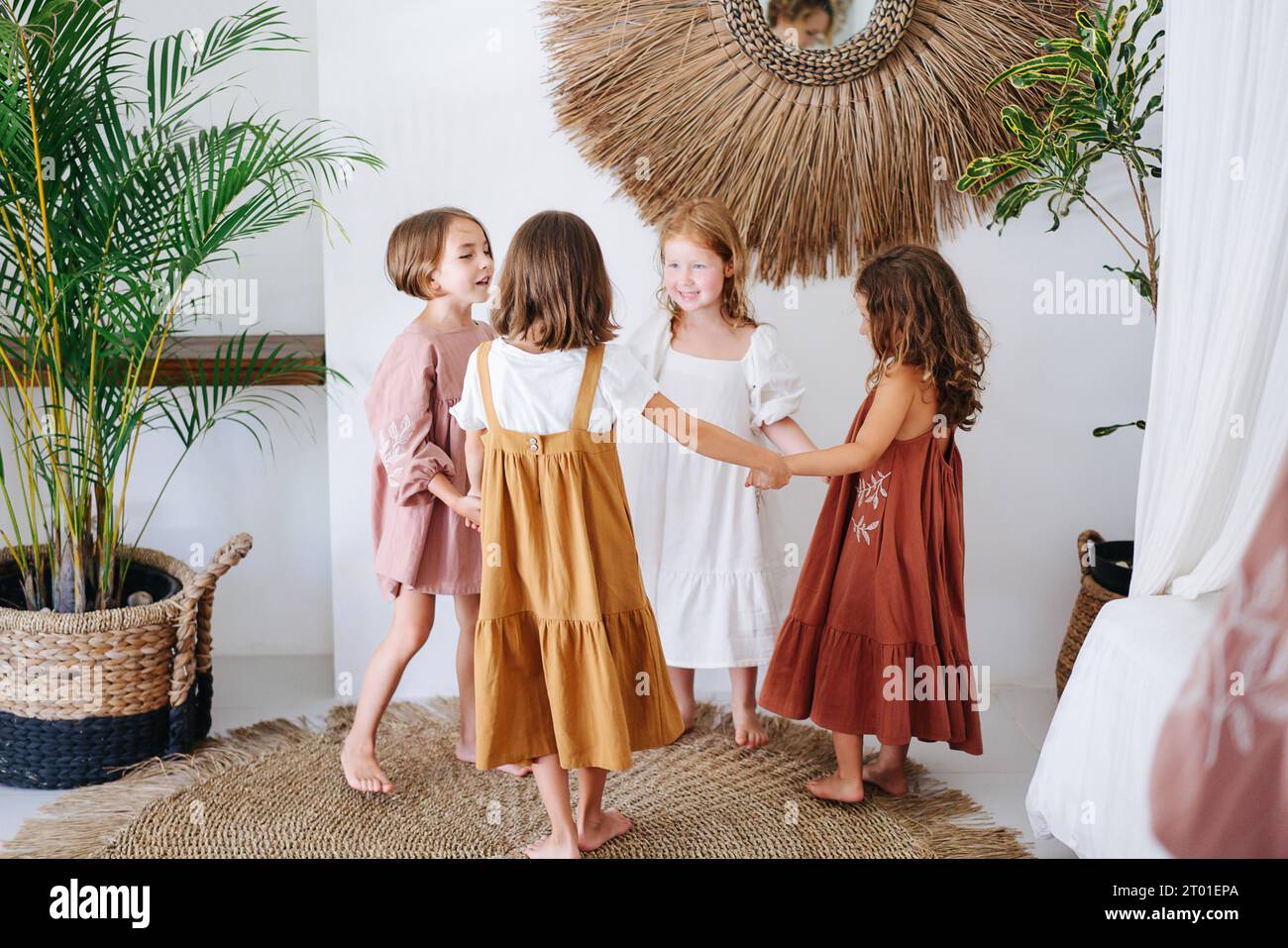 Four children girls had a party, joyfully twirling holding hands Stock Photo