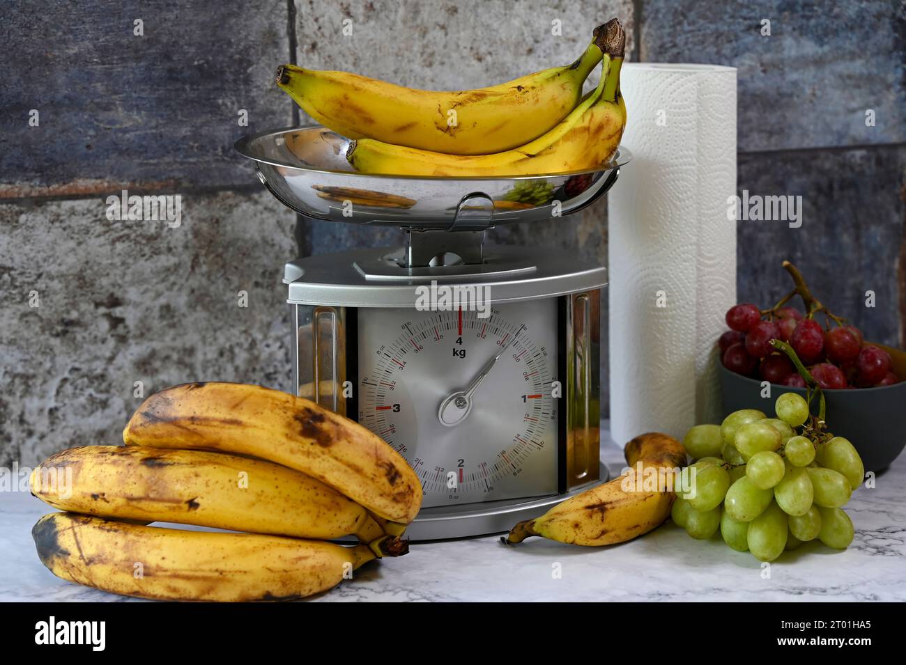Various fruits on a kitchen countertop and on a kitchen scale. Stock Photo