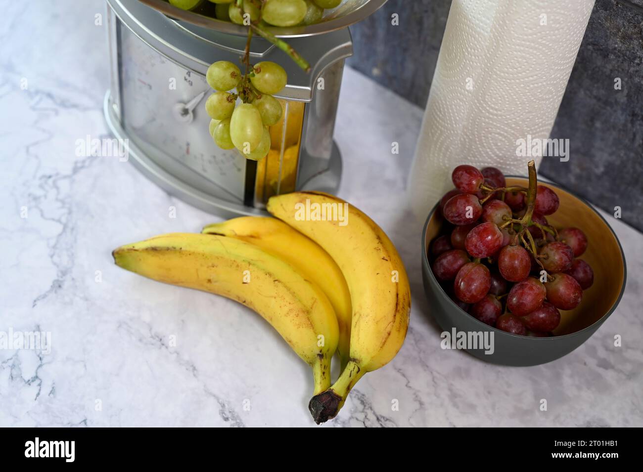 Various fruits on a kitchen countertop and on a kitchen scale. Stock Photo