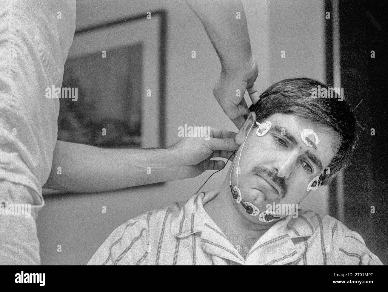 Sleep Technician Sam DeFrancesco places electrodes onto patient Lou ...