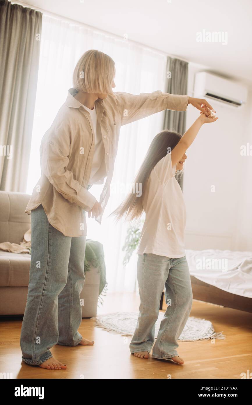 Mom and her daughter child girl are dancing. Family holiday and togetherness. Stock Photo