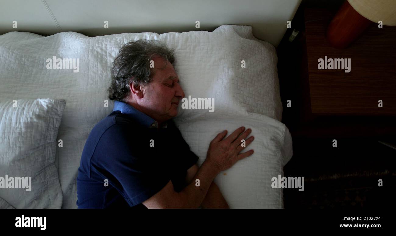 Older man sleeping in bed hi-res stock photography and images - Alamy