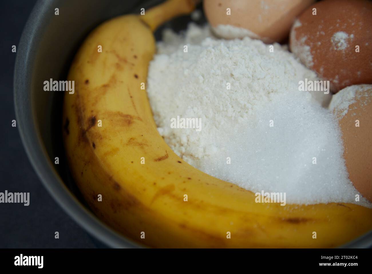 ingredients for a banana cake in a cake tin Stock Photo