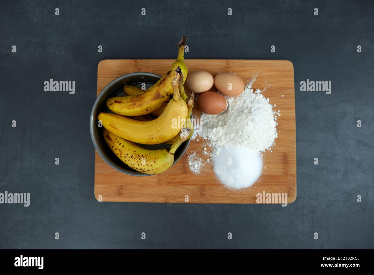 ingredients for a banana cake and a cake tin Stock Photo