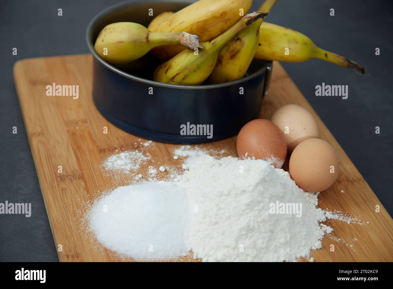 ingredients for a banana cake and a cake tin Stock Photo