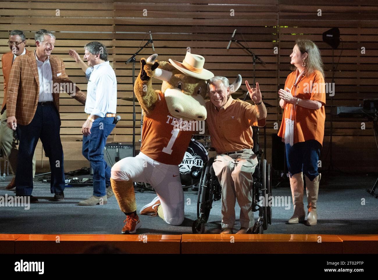 Texas Governor GREG ABBOTT and wife CECILIA ABBOTT pose with University of Texas costumed mascot 'Hook-Em' during a tailgate party hosted by the Abbotts at the Governor's Mansion the evening before a football game between undefeated Texas (4-0) and Kansas (4-0) in Austin on September 29, 2023. ©Bob Daemmrich Stock Photo