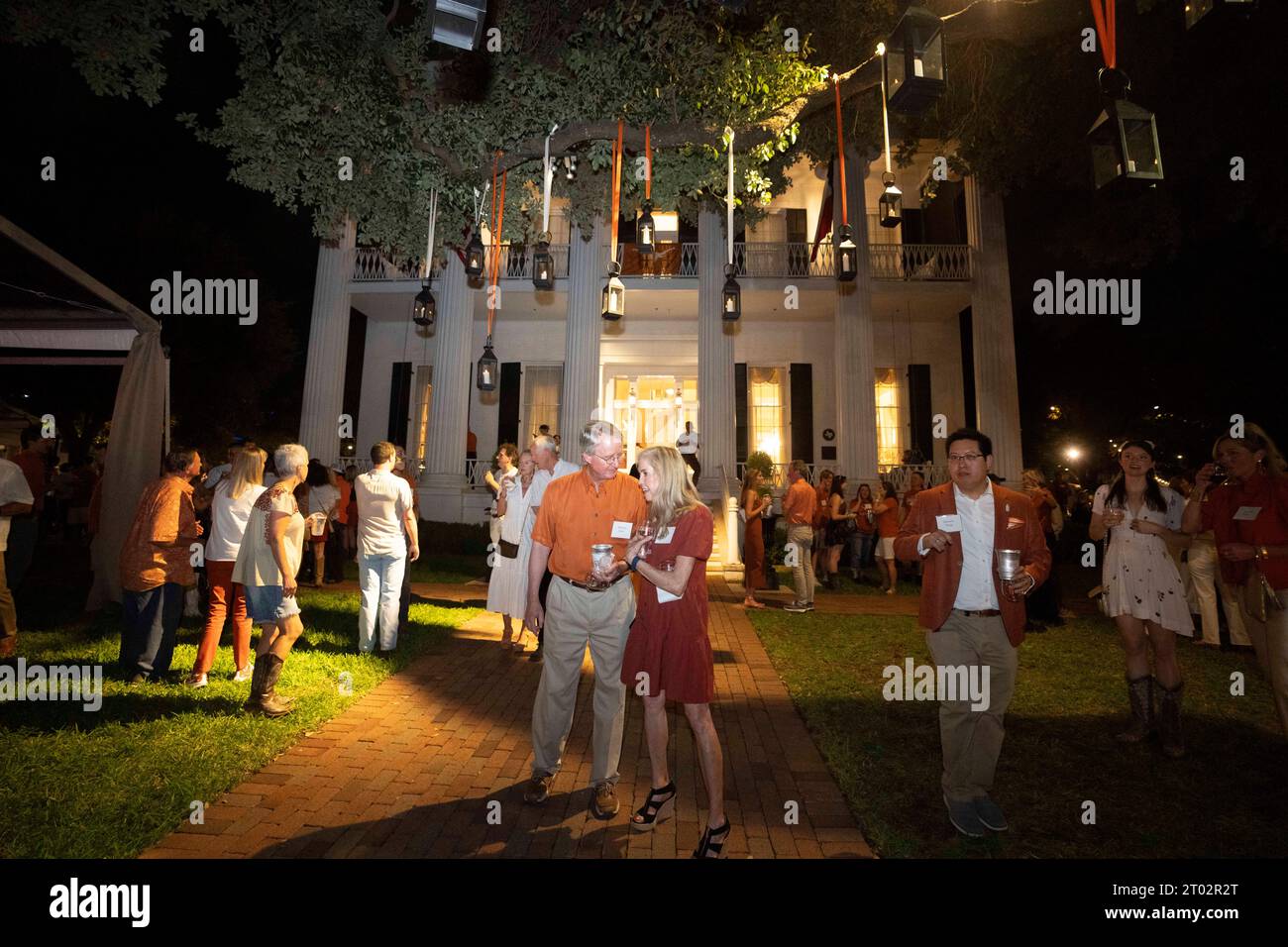 Revelers walk in front of the Governor's Mansion during a 'tailgate party' hosted by Texas Gov. Greg Abbott the evening before a football game between undefeated Texas (4-0) and Kansas (4-0) in Austin on September 29, 2023. Several hundred Longhorn fans and VIPs roamed the grounds and toured the governor's mansion. ©Bob Daemmrich Stock Photo