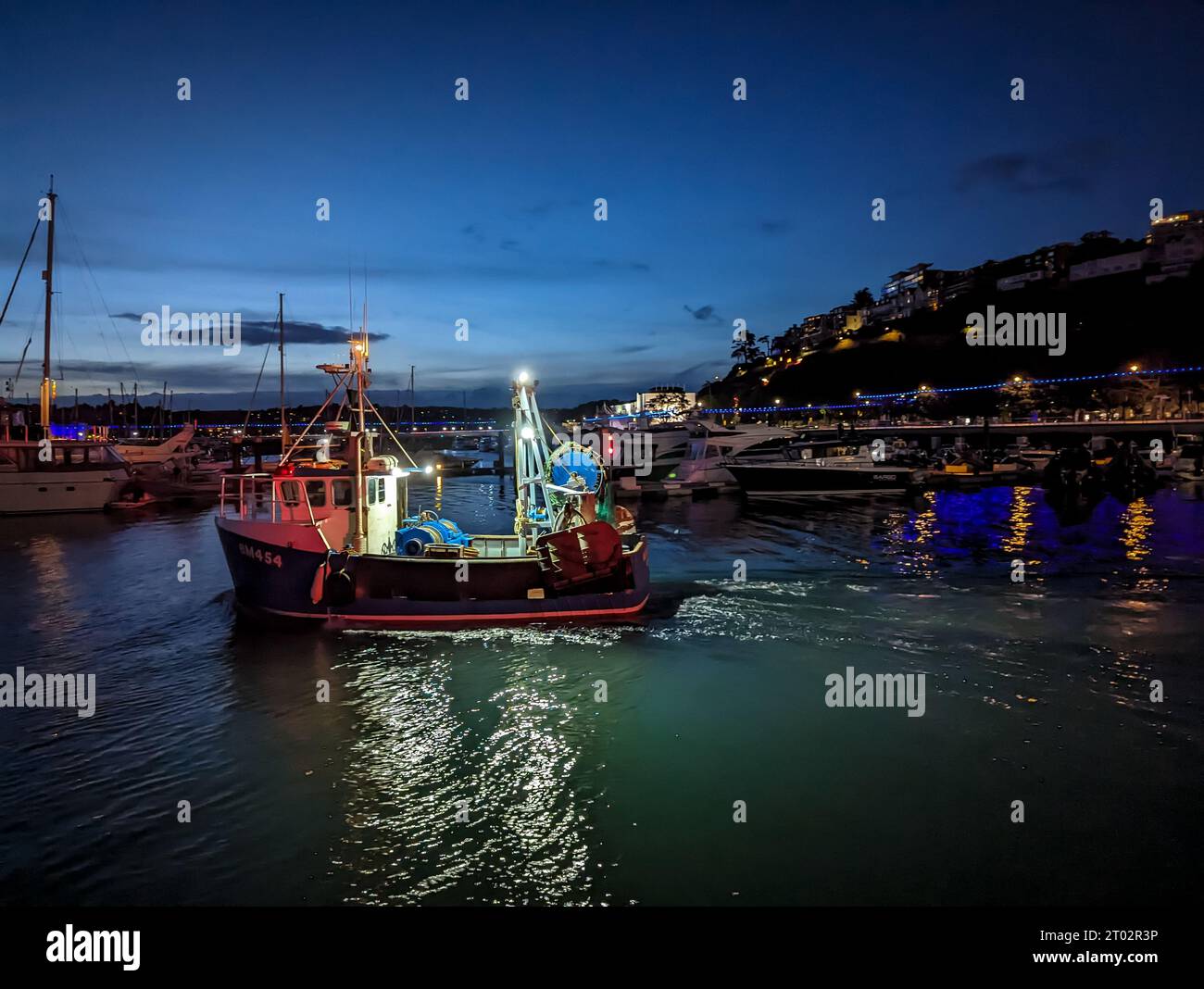 Torquay, UK. 3rd Oct, 2023. A Fishing Trawler Leaves Torquay Harbour at Night. Credit: Thomas Faull/Alamy Live News Stock Photo