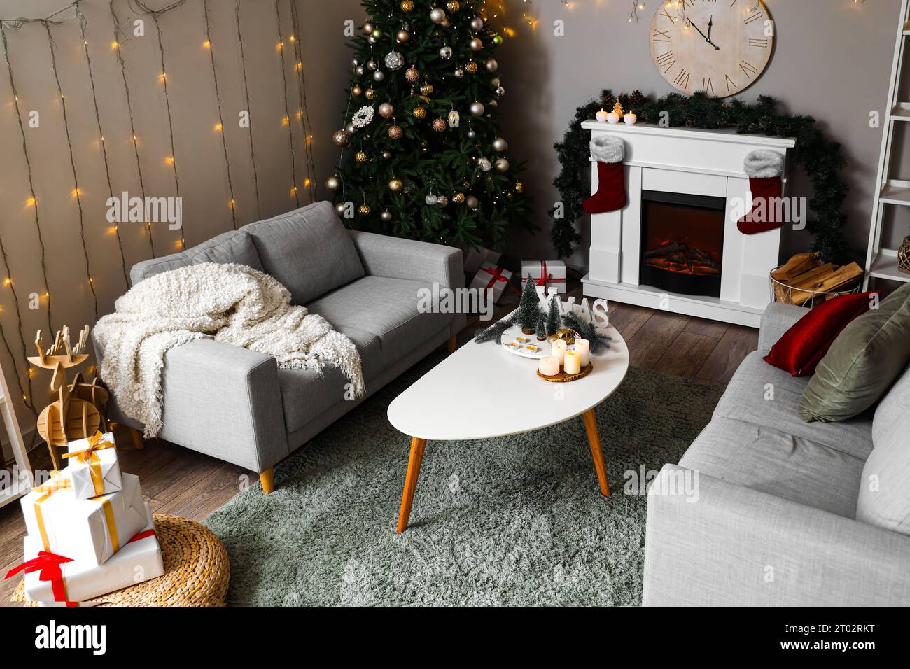 Interior of festive living room with Christmas tree, coffee table