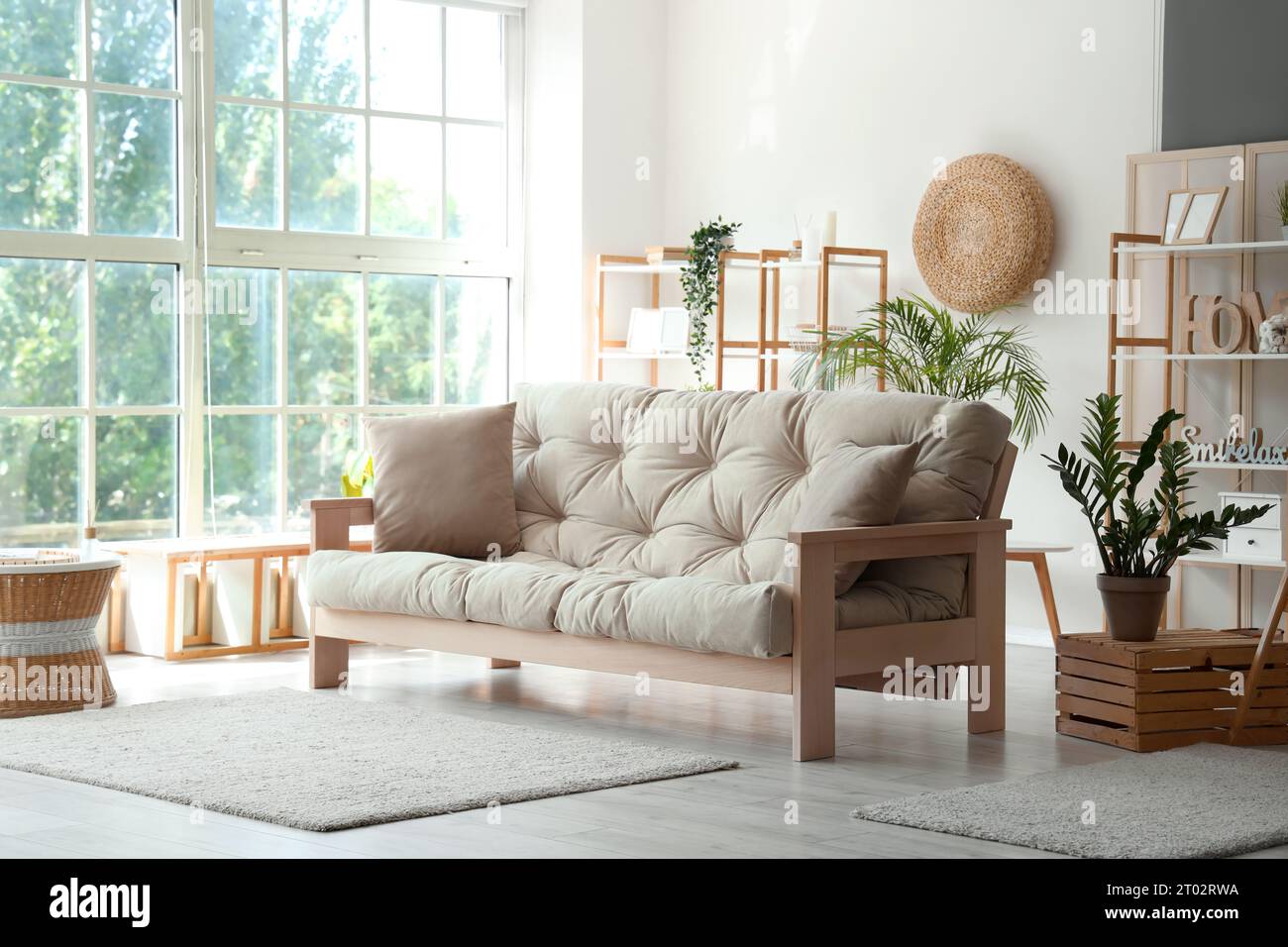 Interior of stylish living room with grey sofa Stock Photo - Alamy