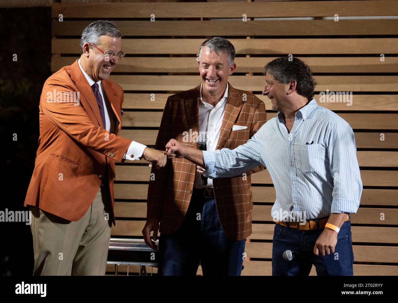 University of Texas President JAY HARTZELL (center) stands between UT Athletic Director CHRIS DEL CONTE (left) and UT Board of Regents President KEVIN ELTIFE at a 'tailgate party' hosted by Texas Gov. Greg Abbott the evening before a football game between undefeated Texas (4-0) and Kansas (4-0) in Austin on September 29, 2023. Several hundred Longhorn fans roamed the grounds and toured the governor's mansion. ©Bob Daemmrich Stock Photo