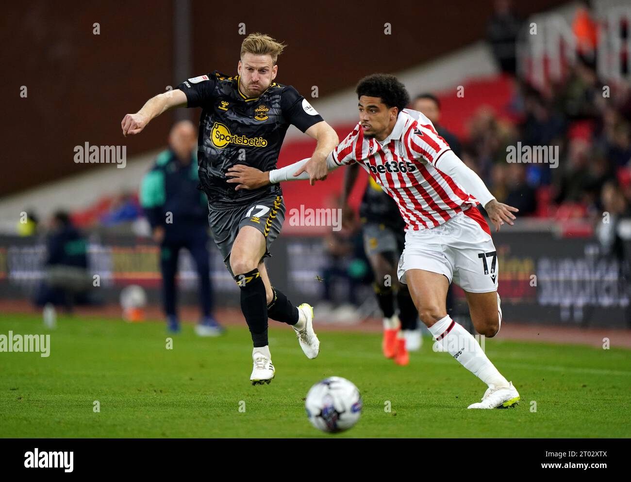 Southampton's Stuart Armstrong (left) and Stoke City's Ki-Jana Hoever battle for the ball during the Sky Bet Championship match at the bet365 Stadium, Stoke-on-Trent. Picture date: Tuesday October 3, 2023. Stock Photo