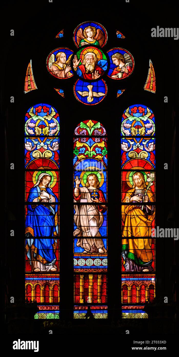 Jesus with Mary and Joseph and also with the Holy Trinity. Stained-glass windows in Church of St Alphonsus Liguori, Luxembourg City, Luxembourg. Stock Photo