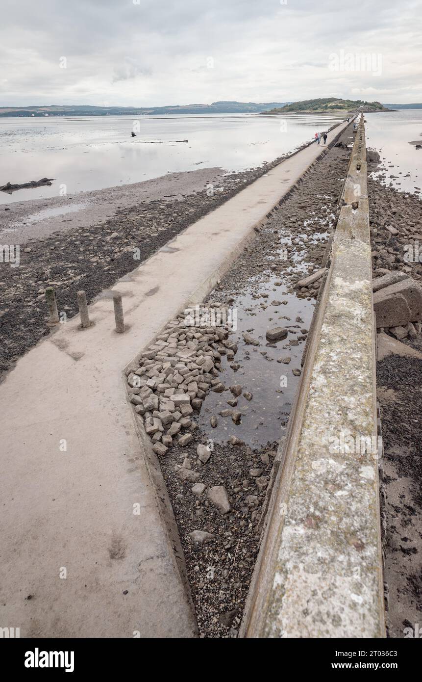 Edinburgh, United Kingdom - August 26th, 2023: When the tide of the Firth of Forth is low Cramond Island is accessible from Silverknowes via this caus Stock Photo