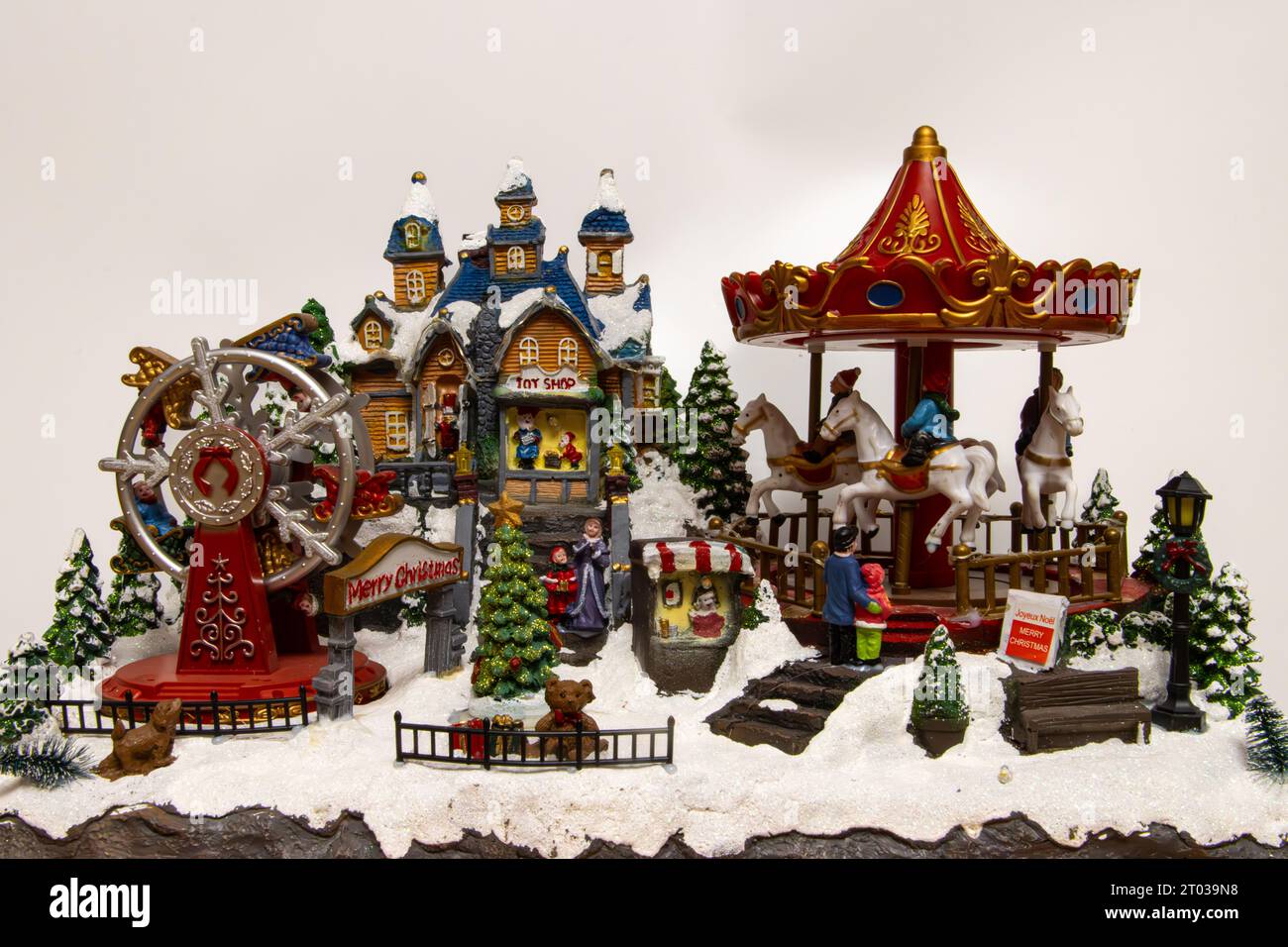 Christmas village miniature with carousel toy shop and ferris wheel Stock Photo Alamy