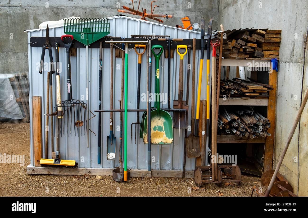 A well-ordered array of garden tools at the Agrarian Kitchen garden at Willow Court, New Norfolk, shovels, spades, forks and rakes at Norfolk in the Derwent Valley, Tasmania. Stock Photo
