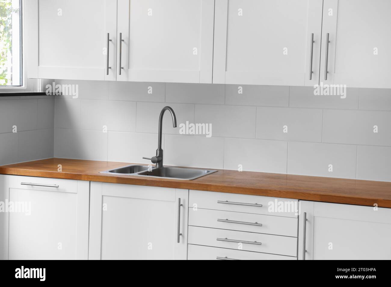 Stylish kitchen interior with wooden countertop and sink Stock Photo ...