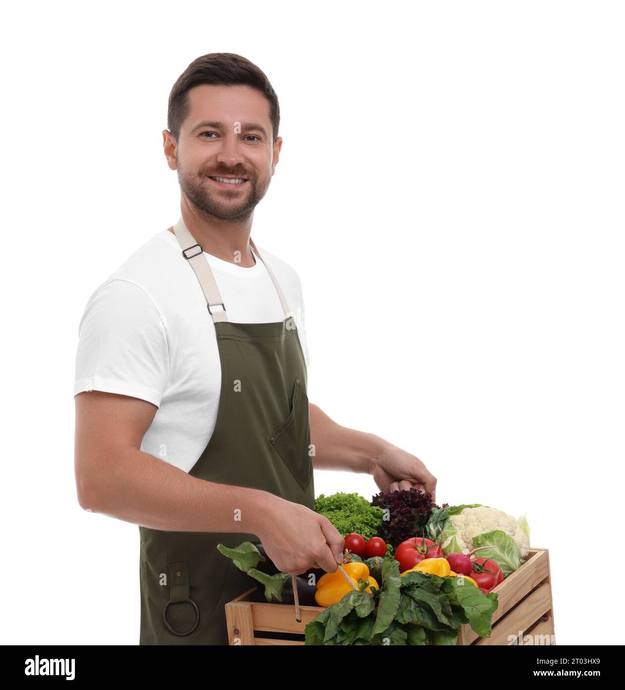 Harvesting season. Happy farmer holding wooden crate with vegetables on ...