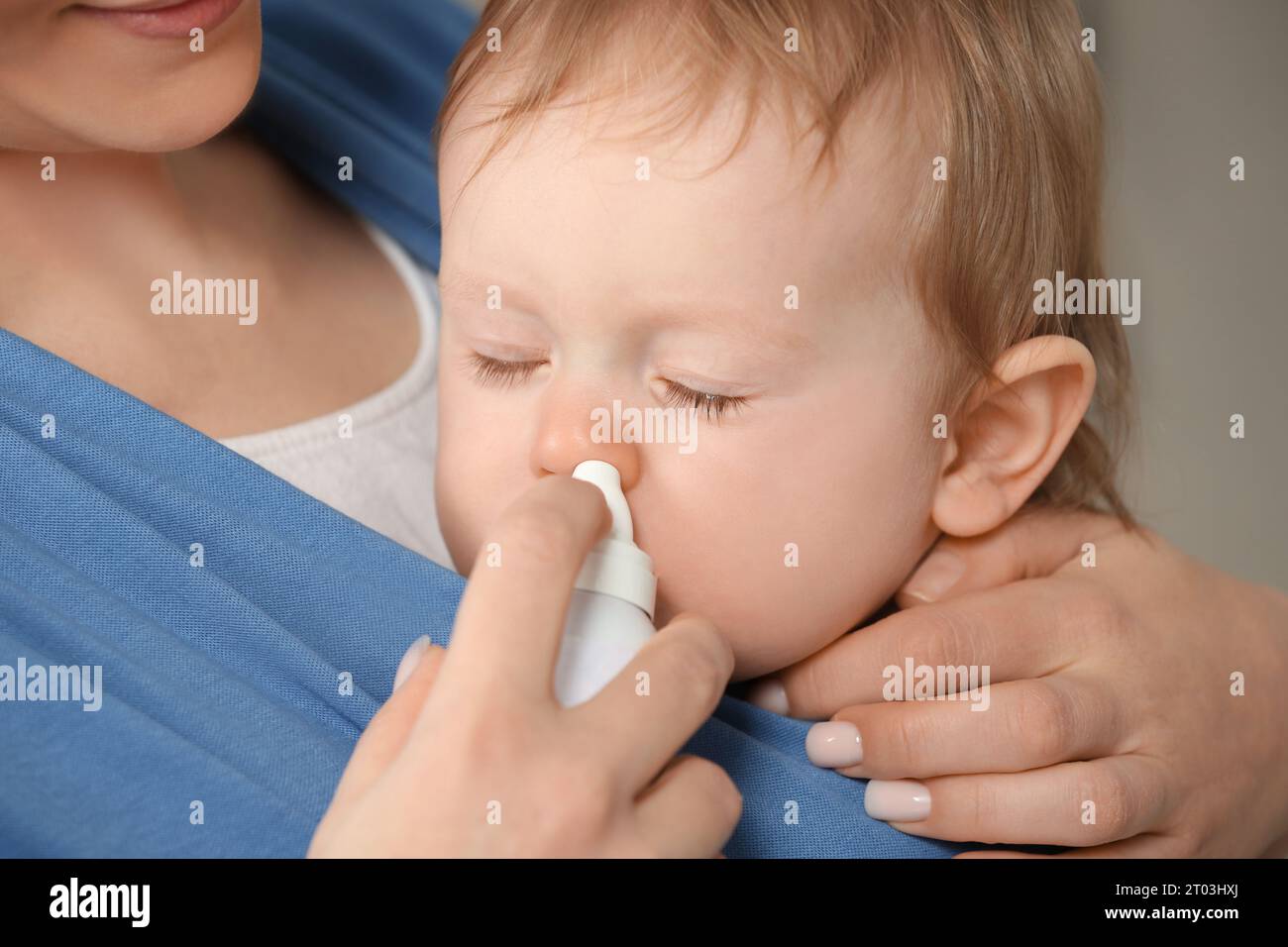 Mother helping her baby to use nasal spray, closeup Stock Photo Alamy