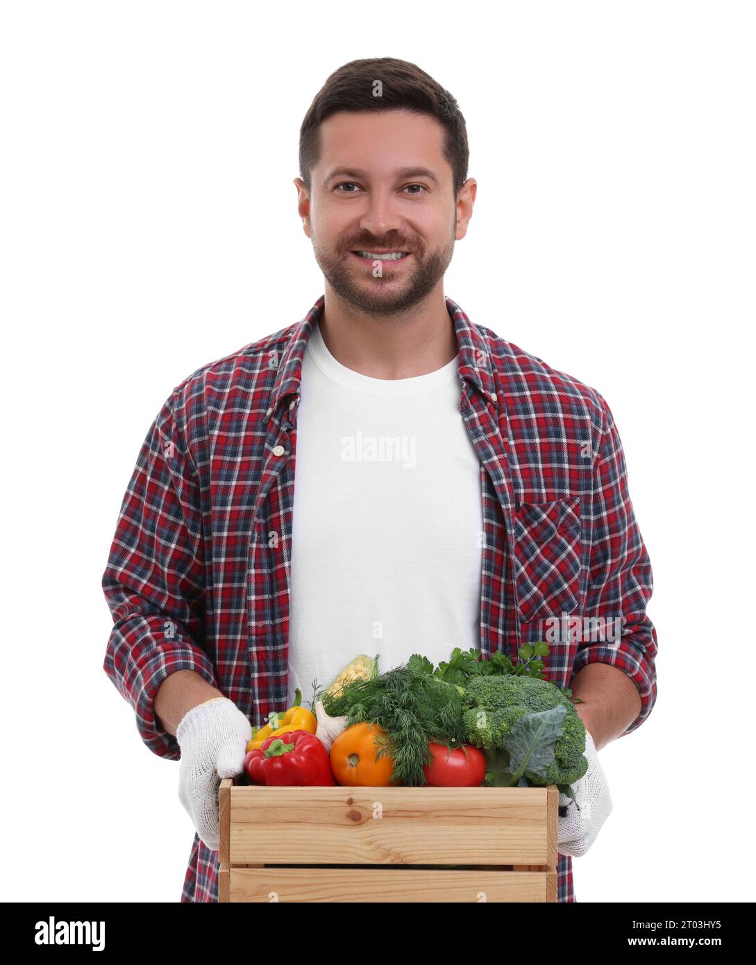 Harvesting season. Happy farmer holding wooden crate with vegetables on ...