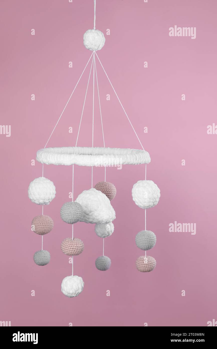 Cute baby crib mobile on pink background Stock Photo Alamy