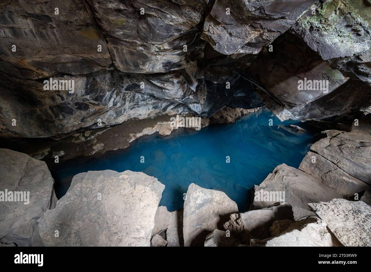 Blue pool in Grjotagja lava cave and fissure in Myvatn, Iceland under autumn afternoon cloudscape. Stock Photo