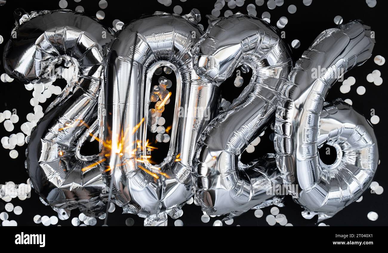 Happy new year 2026 metallic balloons with confetti and sparkler