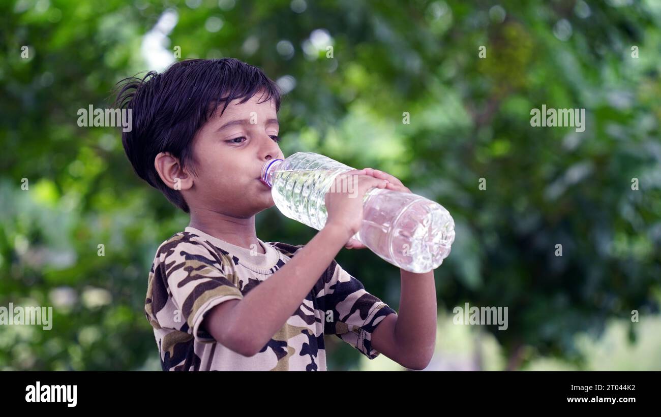 Teen Boy On Beach Holding Water Bottle High-Res Stock Photo - Getty Images