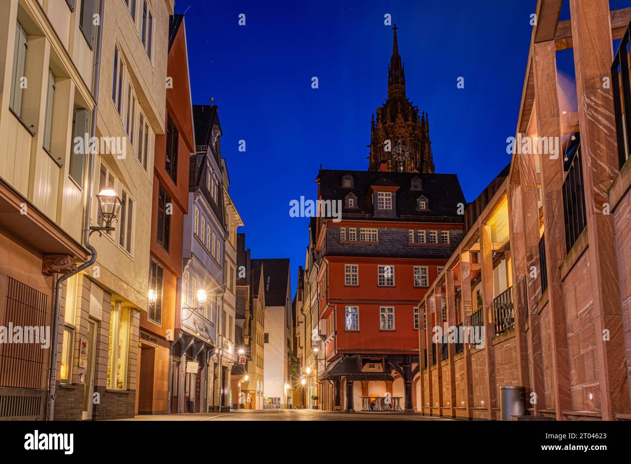 The lights of Frankfurt's New Old Town shine in the morning, while the spire of the Kaiserdom towers in the background, New Old Town, Frankfurt am Stock Photo