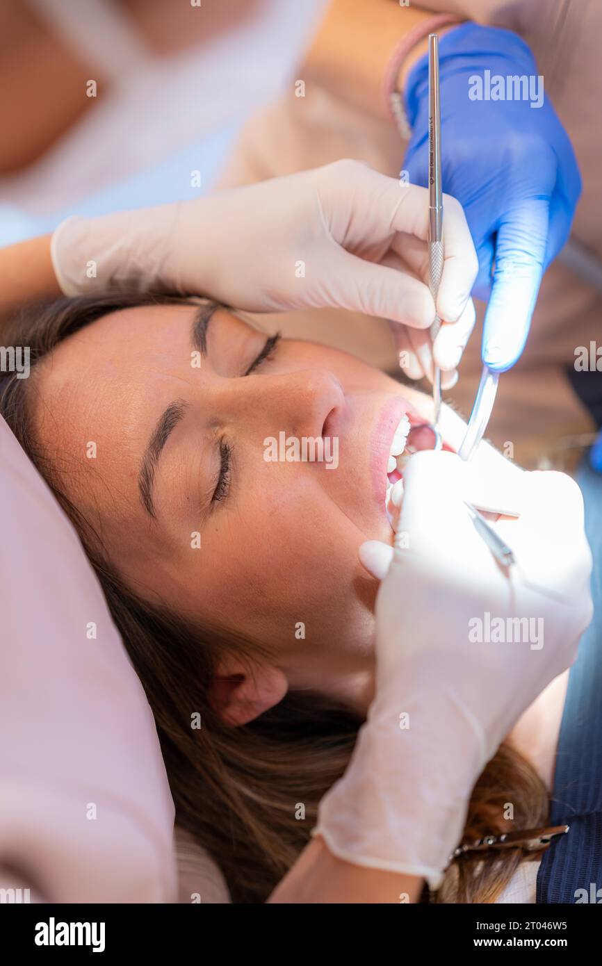 Vertical close-up of a patient with the mouth open during a dental exam Stock Photo