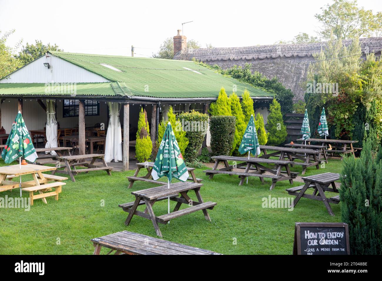 The Trusty Servant Inn in Minstead Lyndhurst is a public house serving food and providing accommodation, the beer and food garden shown,England,UK Stock Photo