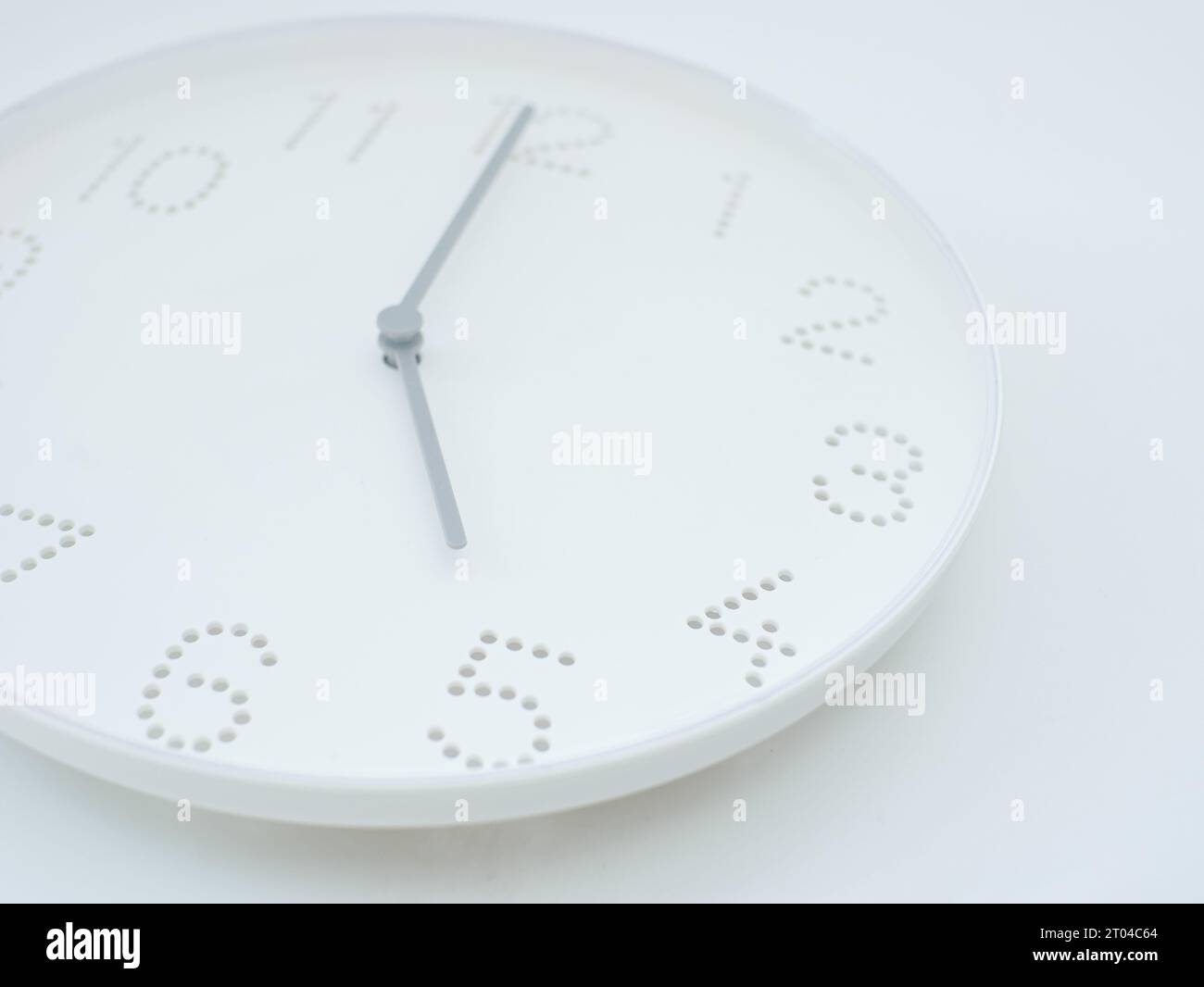 white wall clock shows the time 5 am or pm on white background Stock Photo Alamy
