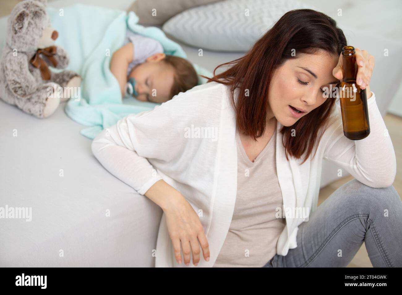 drunk reckless woman drinking alcohol near baby Stock Photo Alamy