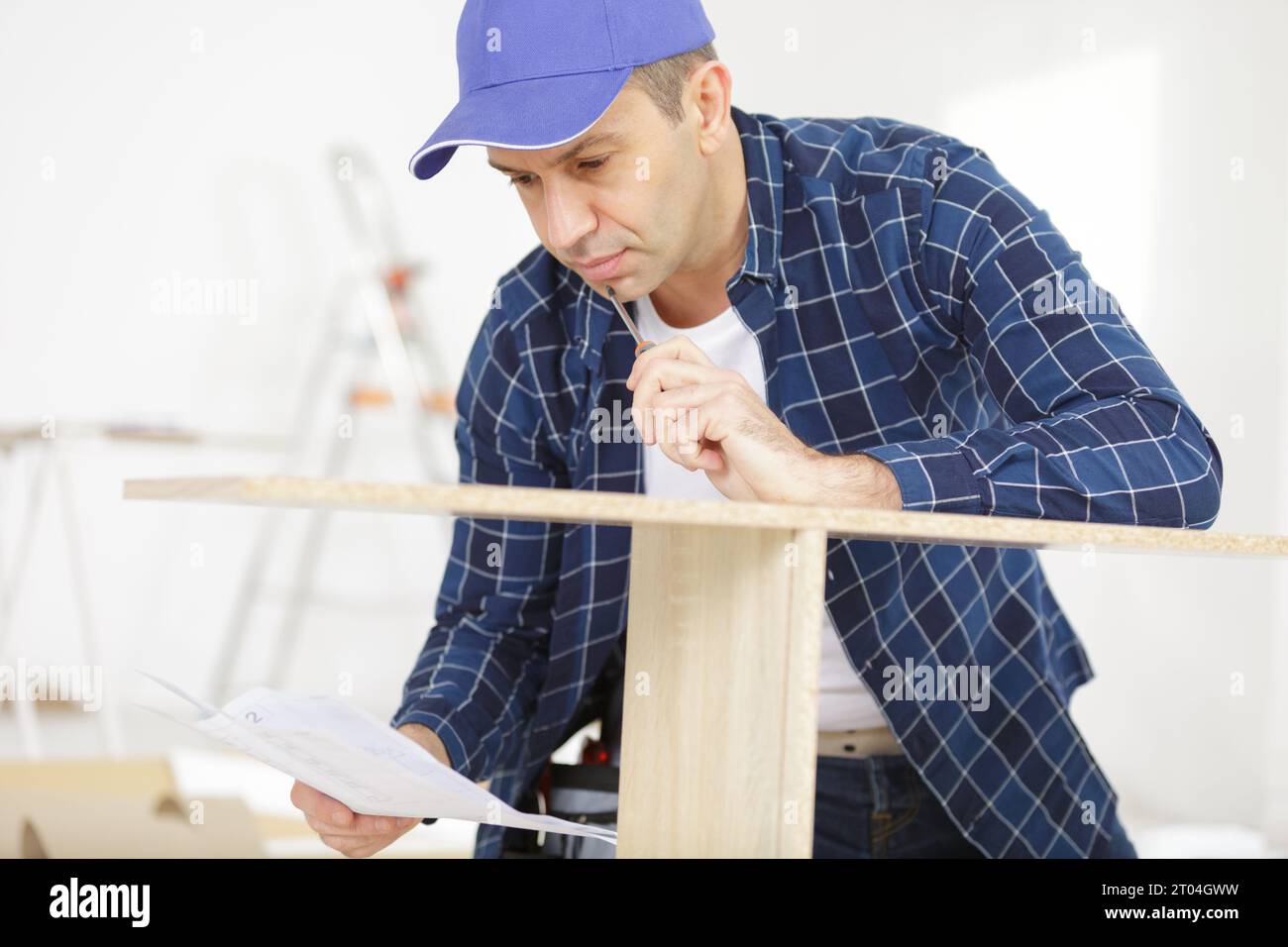 a man is assembling furniture Stock Photo