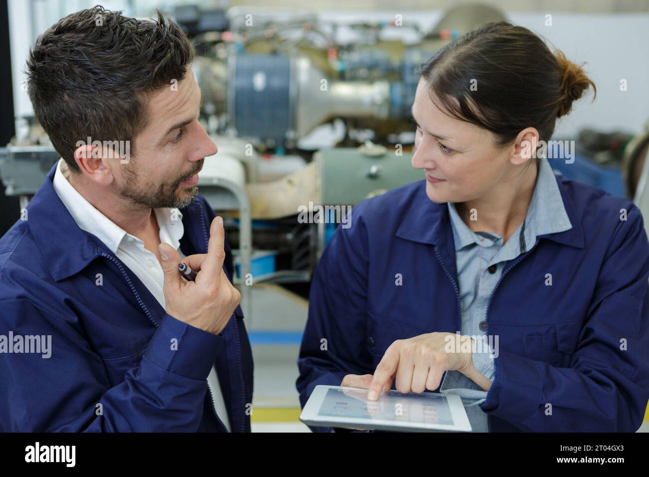 2 workers discussing near factory Stock Photo