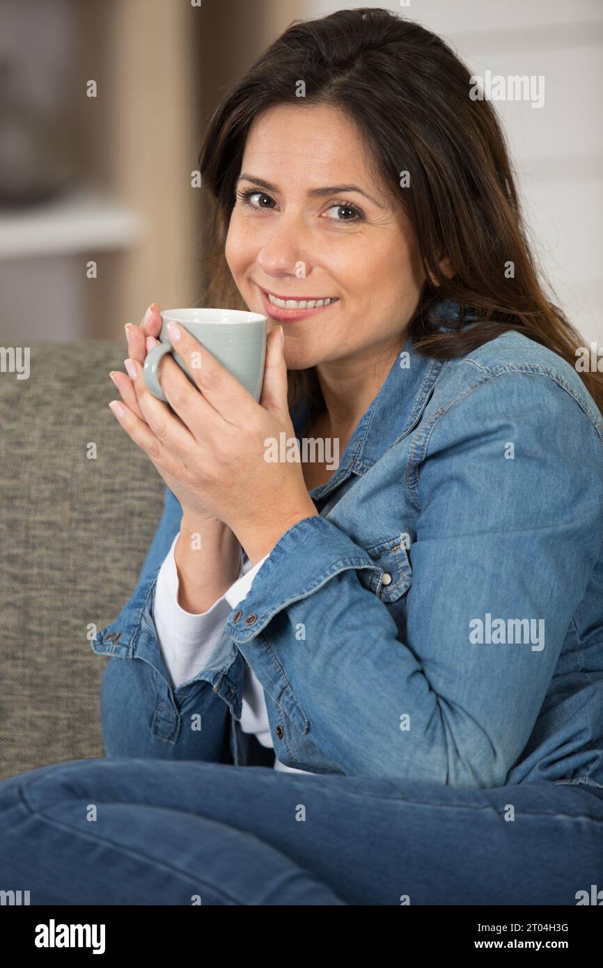 happy female business owner having a coffee break Stock Photo Alamy