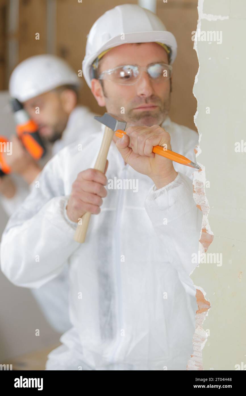builder with a chisel and hammer Stock Photo Alamy