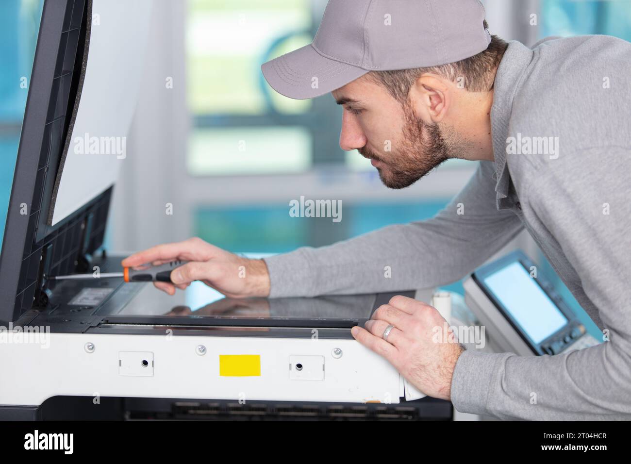 young apprentice fixing cartridge in photocopy machine Stock Photo